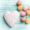 Bright cake pops and white heart on turquoise painted wooden b