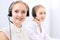 Bright call center office. Two blonde women in a headset