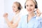 Bright call center office. Two blonde women in a headset