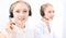 Bright call center office. Two blonde women in a headset