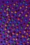Bright candy scattered on a flat purple background. View from above
