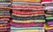 Bright cashmere shawls in the bazaar. Background with oriental shawls