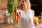 Bright cheerful lady picking up some carrots