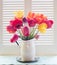 Bright and Cheerful Tulip Bouquet in a White Tin Vase bathed in Airy Natural Window Back Light with Painted Wooden Shutters and ro