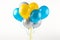 Bright and cheerful yellow and blue balloons floating against a pristine white background.