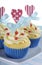 Bright and cheery red white and blue decorated cupcakes with heart toppers