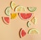 bright citrus fruits in even geometric layout on a pastel background