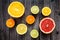 Bright citrus fruits on a wooden dark background.