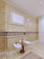 Bright classic bathroom interior design in large luxury house with beige wood cabinets
