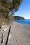 bright clear blue skies over a rocky beach