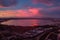 Bright cloudy sky purple violet pink colors sunset over Torrevieja salt lake Las Salinas view from above