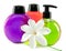 Bright color cosmetic small bottles with the dispenser and white flower.Still-life on a white background