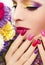 Bright color manicure and makeup.