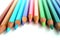 Bright color pencils horizontal wave on white background with pink central pencil on focus