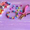 Bright colored bracelet made of plastic buttons. Handmade cute kids jewelry. Children\'s diy
