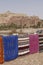 Bright colored carpets frame the hilltop village of Ait ben Haddou