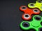 Bright colored fidget finger spinners on dark background