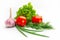 Bright colored fresh vegetables on a white background. Tomato, green onion, garlic, lettuce, dill