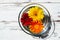 Bright-colored gerbera daisies in transparent bowl with water