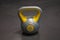 Bright colored plastic kettlebell weight weighing four kilograms