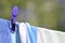 Bright colored towels pegged to a washing line against a blurred tree background