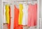 Bright colorful dress hanging on coat hanger