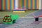 Bright colorful funny bench on nursery playground with soft rubber flooring on bright sunny summer day. Children activities and