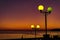 Bright and colorful lights on the waterfront at dusk and night, seascape, green and yellow light, blue starry sky. Russia, the vil
