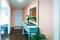 Bright and colorful peach and aqua turqoise front door entryway foyer with hardwood floors