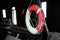 A bright colorful red-white marine lifebuoy hangs on a pillar in an abandoned ship