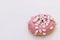 Bright and colorful sprinkled donut on a white background. Assortment of donuts of different flavors. Pink glazed