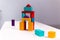 Bright colorful wooden blocks toy. Bricks children building tower, castle. Red, orange and blue.