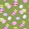 Bright colors Macarons cake Watercolor seamless pattern on green background. Colorful sweet french desserts. Fabric