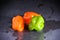 Bright colourful green and orange habanero hot peppers on table