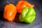 Bright colourful green and orange habanero hot peppers on table