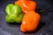 Bright colourful green and orange habanero hot peppers on table