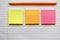 Bright colourful pencil and sticky notes on a blank ruled paper background