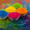 Bright colourful powdered pigments in glass bottles for Indian holi festival on dark slate background, copy space. Colorful gulal