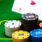 Bright columns of poker chips behind which falls a pair of aces