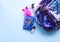Bright composition of fashion accessories. Glitter sequins backpack, notepad, funny pen, nail polish. Different objects on soft
