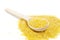 Bright corn grits with a wooden spoon are on a white background