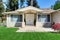 Bright covered porch with columns and sitting area with table set