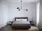 Bright and cozy modern bedroom interior design with white walls, plaster moldings on the walls, and large window