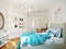 Bright and cozy modern bedroom interior design with white walls, turquoise curtains and blanket