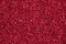 Bright crimson background with glitter. Red glitter texture.