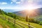 Bright dawn in mountains. View of picturesque meadow