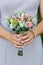 Bright delicate bouquet of the bride in the hands