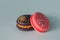 Bright delicious macaroons. French sweets. Pink and black cake