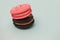 Bright delicious macaroons. French sweets. Pink and black cake