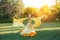 Bright divine sun light. Art Fantasy happy woman dancing spinning hand raised yellow silk dress, cape train fluttering